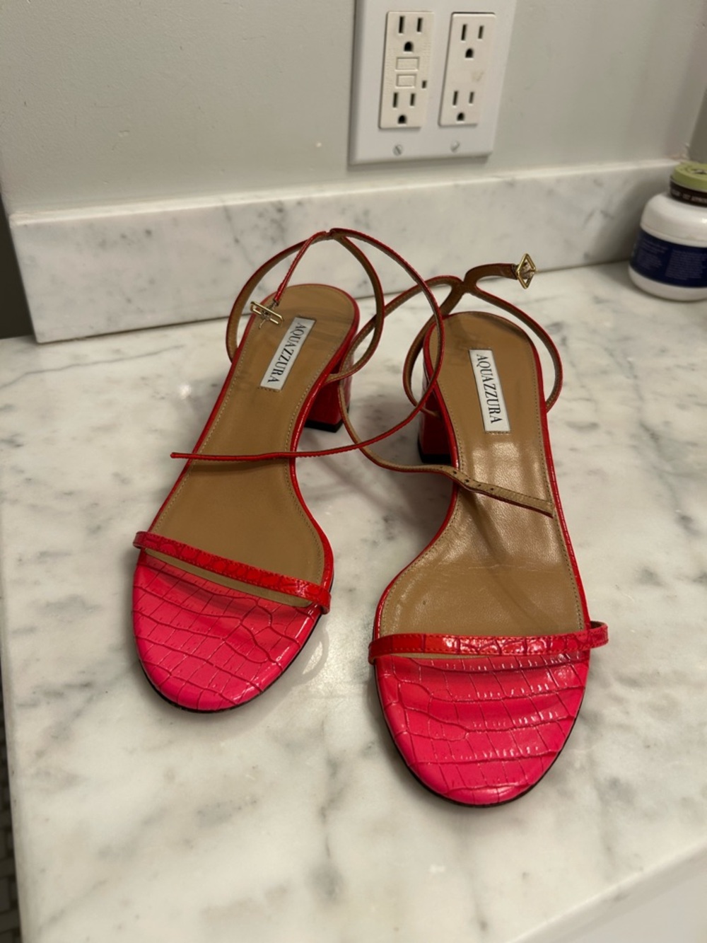 Aquazzura Hot Pink Croc-Effect Ankle-Strap Sandals with red heels.